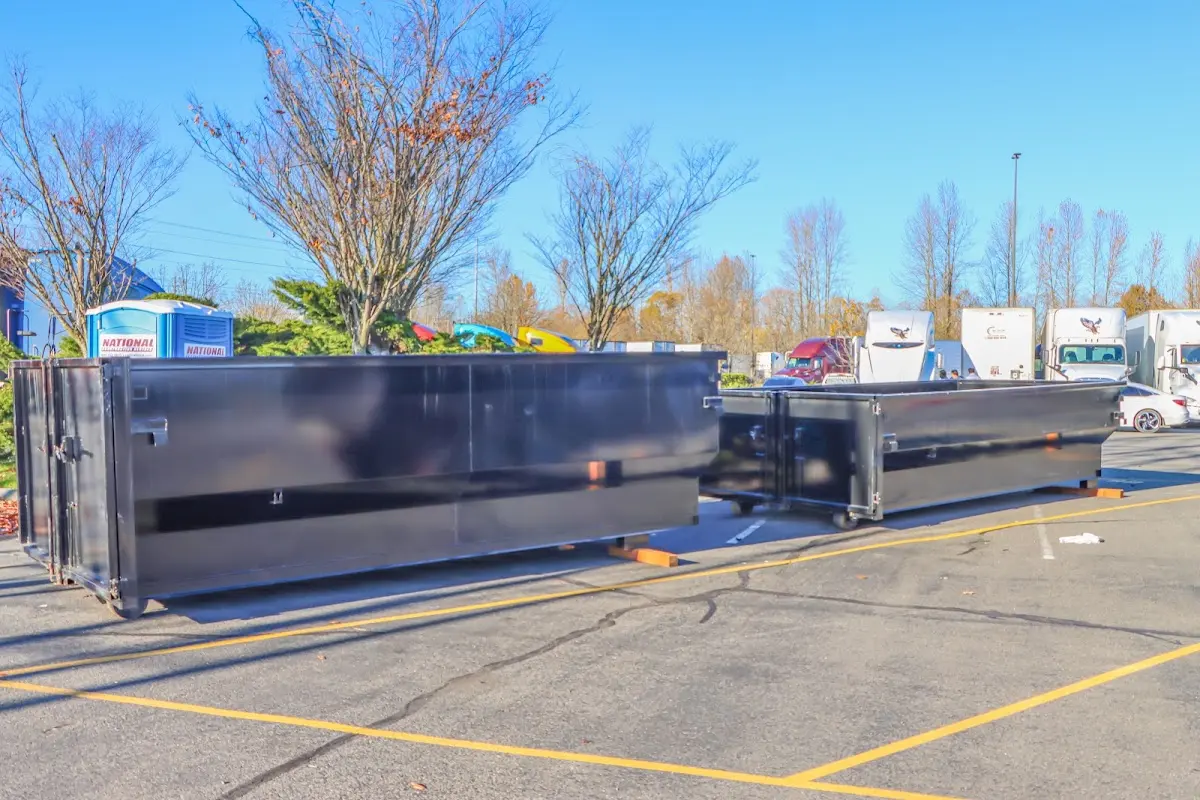 Professional dumpster rental service with roll-off container on residential driveway in Eaton